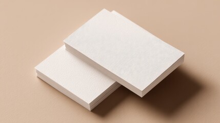 Stack of blank white paper sheets neatly arranged on a light beige background for printing or writing purposes