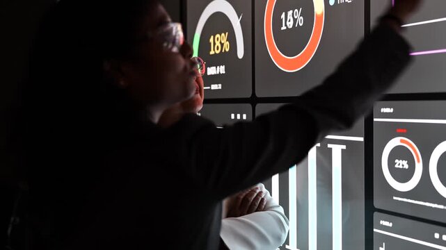 woman employees in suits and female staffs stand presenting sales data graph and customer data report, discussing and report summarizing the plan strategy in the company executive meeting conference 