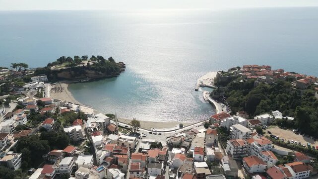 Aerial perspective of a sandy beach located on Adriatic shore in the town of Ulcinj, Montenegro. Flying forwards.