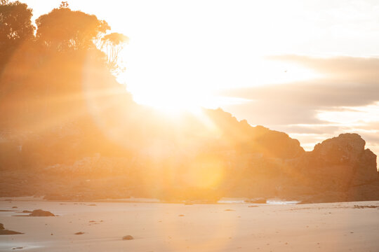 Vibrant morning sunshine beaming past Hedgehog Island at Seal Rocks