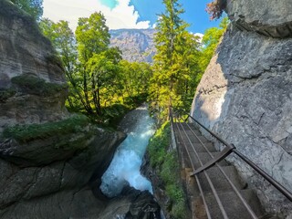 Ultra wide shot of the final section of the Trummelbach underground glacier waterfalls with a view of the Lauterbrunnen Valley in Switzerland.