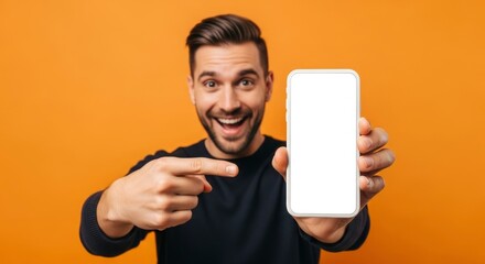 A smiling man points to a blank white smartphone screen set against an orange background