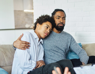 Father with his teenage son at meeting with social worker, psychologist discussing mental health...