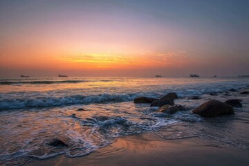 Sunrise over tranquil ocean beach with rocks
