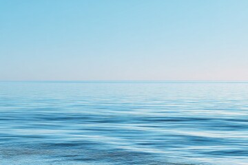 Fototapeta premium Calm, flat, light blue ocean meeting a pale blue sky