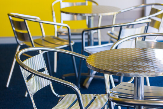 silver chairs and tables in an empty cafe