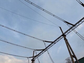 High-Voltage Power Lines and Transmission Towers against a Serene Sky Scape showcasing energy...