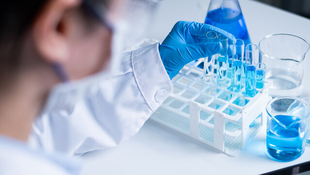 Professional Asian woman scientist chemist technician experiment research in chemistry laboratory data analysis result report scientific innovation document