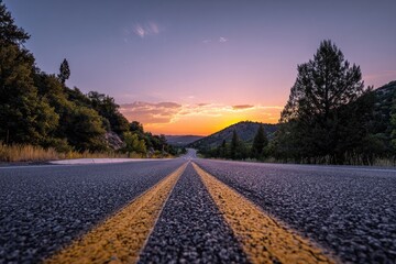 Asphalt road disappearing into a vibrant sunset vista