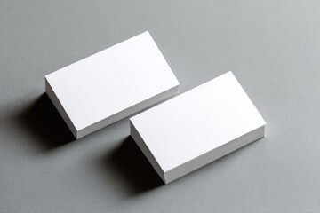 Two blank business cards, light gray background