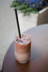 Close-up of an iced cacao drink on a table at a street cafe in summer.