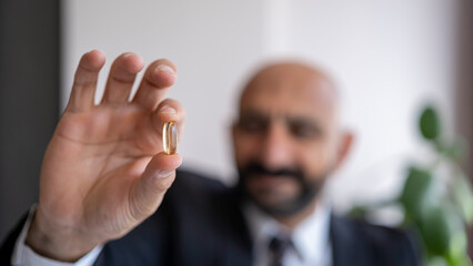 Omega 3 pill in man's hand