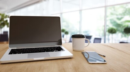 Fototapeta premium Modern Workspace with Laptop, Smartphone, and Coffee Cup on Table