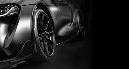 Front view of LED headlights sport car on black background