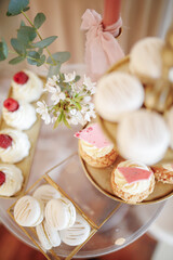 Elegant dessert table with macarons and cupcakes