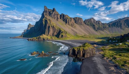 Dramatic coastal landscape. Dark sand beach meets rugged mountains