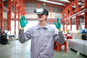 Engineer or technician wearing virtual reality glasses(VR) in the factory