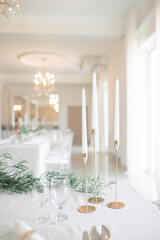 Elegant Table Setting with Candles and Greenery