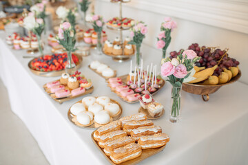 Elegant Dessert Table with Assorted Pastries and Flowers