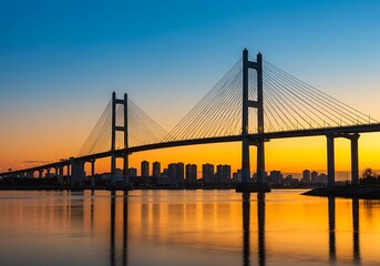 Yokohama bay bridge illuminated at sunset with city skyline and calm water reflection