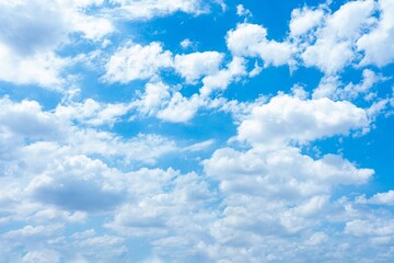 Bright blue sky filled with fluffy white cumulus clouds A vivid daytime scene