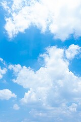 Vivid blue sky filled with fluffy white cumulus clouds A bright sunny day scene
