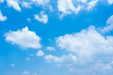 Vivid blue sky with scattered cumulus clouds A high resolution image showcasing a bright sunny day