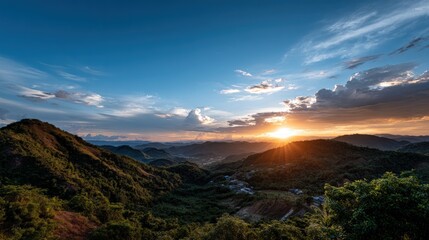 A breathtaking vista of rolling hills and valleys bathed in the warm hues of a magnificent sunset.