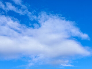 Naklejka premium Fluffy White Clouds in a Bright Blue Sky
