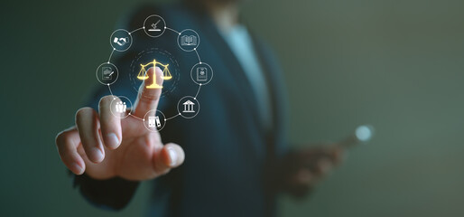 Businessman interacting with virtual justice scale and legal icons, representing business law,...
