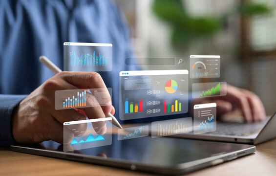 Businessman analyzing data on digital tablet with futuristic graphs and charts. Concept of big data, digital marketing, financial analytics and business intelligence.