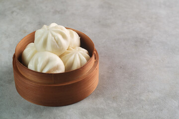 negative space. Bakpao Coklat, chinese steamed buns with chocolate paste on bamboo basket
