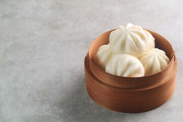 negative space. Bakpao Coklat, chinese steamed buns with chocolate paste on bamboo basket

