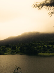 Fototapeta premium mountain covered in fog during sunset