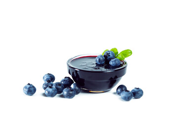 Blueberry jam with berries isolated on white background.