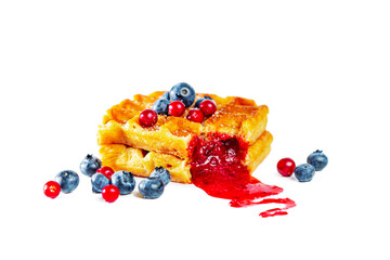 Belgian waffles with fresh berries and jam isolated on white background.