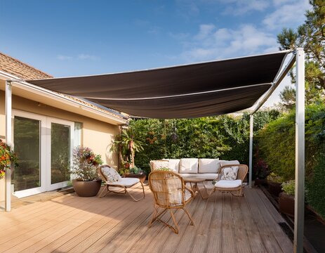 motorized retractable awning extending over a stylish patio with furniture outdoor luxury sun protection
