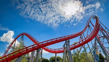 red roller coaster on a sunny day against a blue sky with clouds highlighting the thrilling twists and turns of the ride
