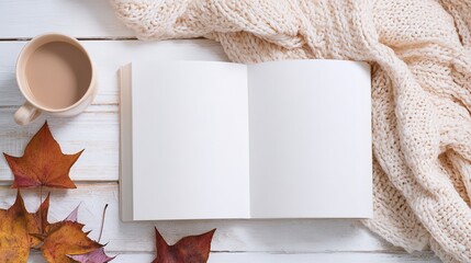 White blank notebook mockup on white wooden table with autumn leaves, coffee cup and knitted blanket, flat lay top view with copy space for blog design, social media content