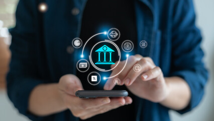 A person using a smartphone with a digital banking app showing financial technology icons, representing fintech services, online payment, and mobile financial innovation.