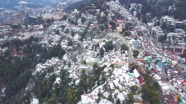 Shimla, Himachal Pradesh, India - February 1st 2025 - A Drone view of Shimla after snowfall offers a breathtaking panorama of the city and the dense pine & deodar forests, colonial-era architecture.