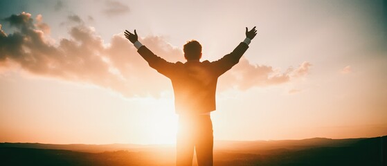 silhouette of a man at sunset with open arms