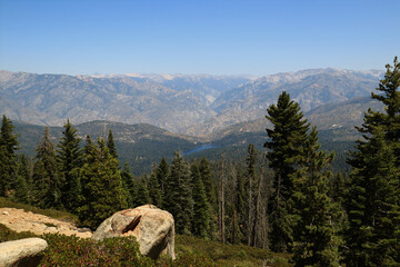 A high-altitude lake surrounded by mountains and dense forest