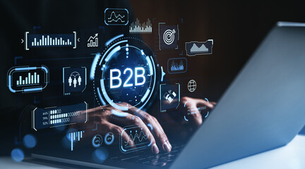 B2B digital marketing technology interface concept with futuristic icons and analytics visuals over laptop and hands typing in dark environment.