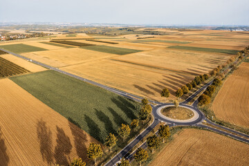 A roundabout surrounded by fields and meadows from a bird's eye view