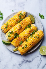 Grilled corn with cilantro, spices and butter.