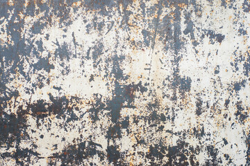 The walls are covered in peeling paint and have a rough texture. The blue color of the walls is faded and has a worn appearance. The walls have numerous cracks and holes.