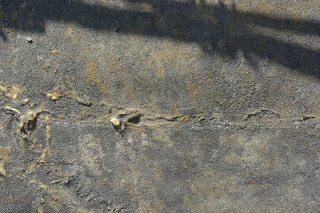 An unusual, worn, antique background is made from pieces of thick fabric with cement, painted with old yellow paint.