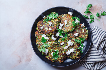 Green zucchini pancakes with feta and cilantro. Vegetarian breakfast recipe.