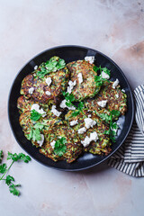 Green zucchini pancakes with feta and cilantro. Vegetarian breakfast recipe.